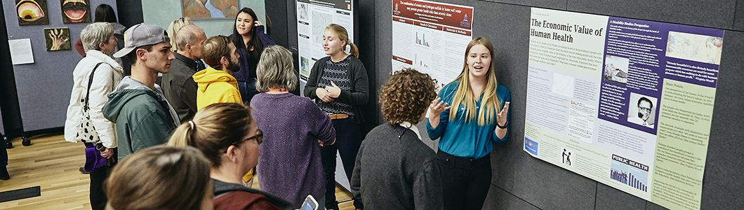 Students view a poster presentation