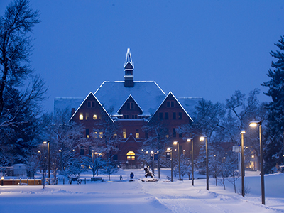 Montana Hall at night in winter.