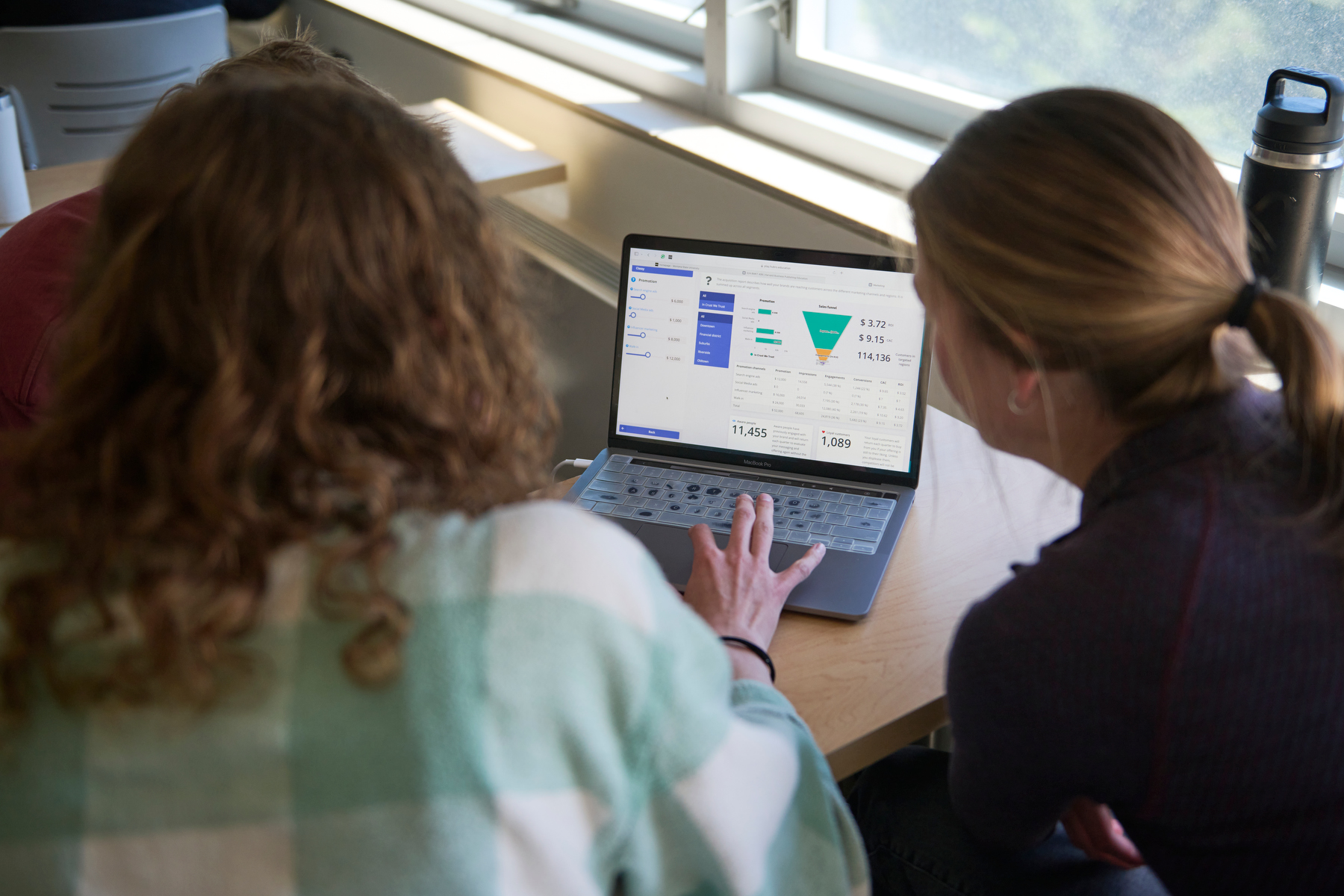 Students review homwork for marketing class