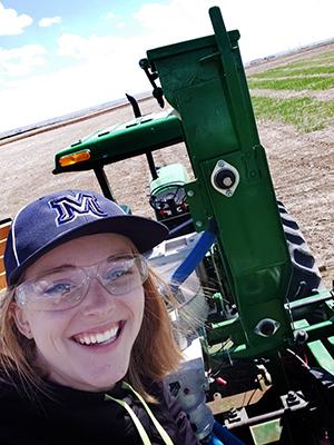 Beth Wallace on a tractor seeding barley