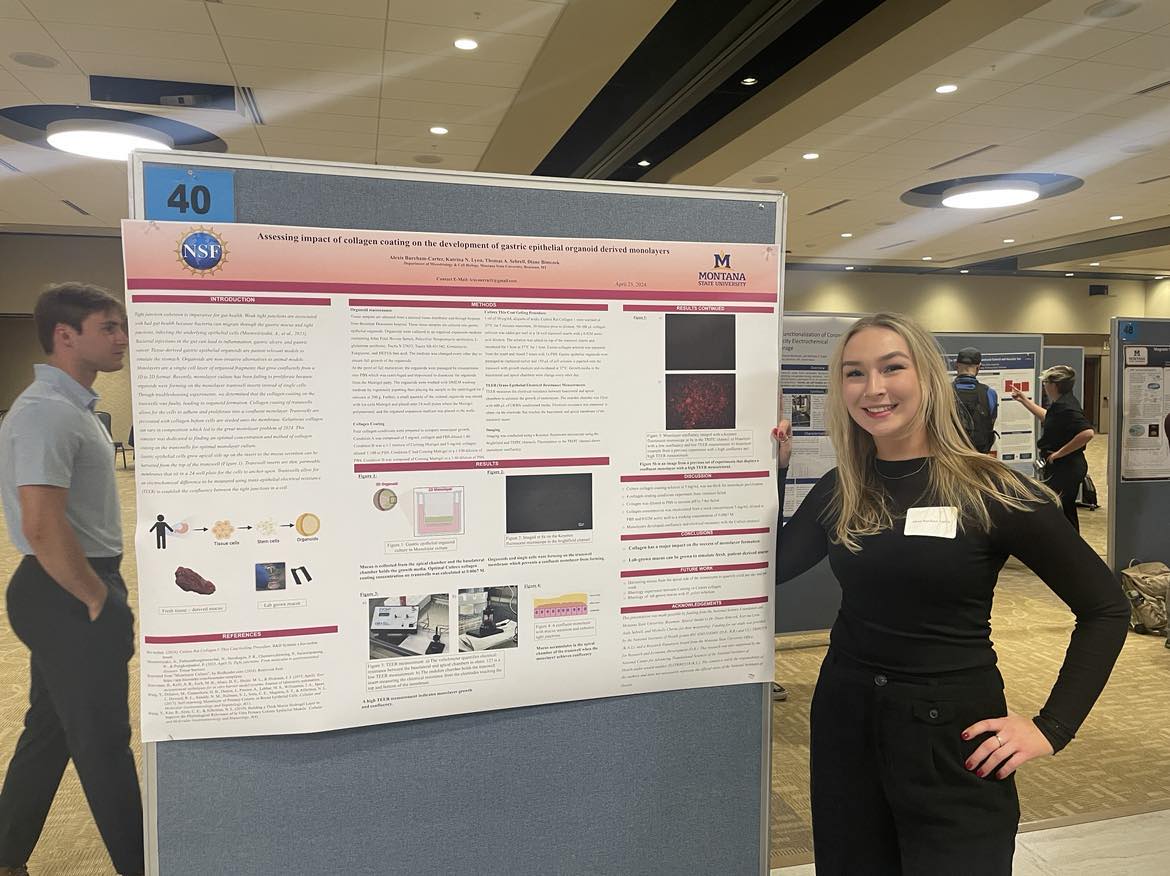 Lexi standing at her research poster
