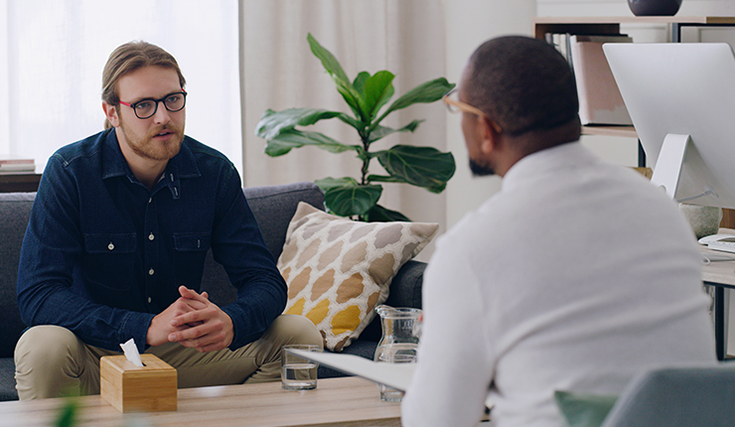 Man in blue shirt with counselor