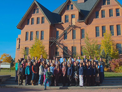 Faculty standing in front of Montana Hall