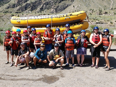 4-H members in front of a boat