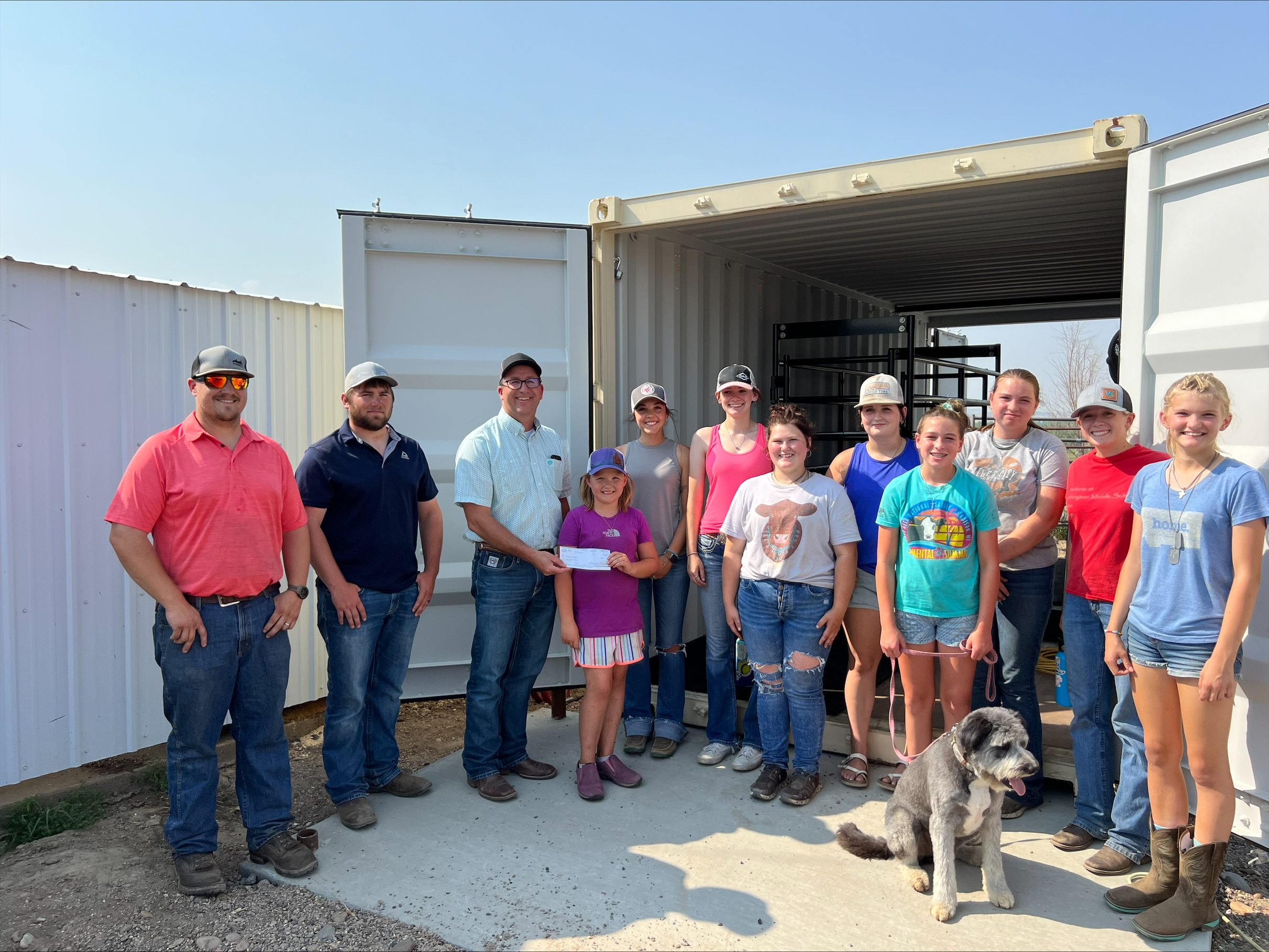 CHS Farmers Elevator presenting Dawson County 4-Her's with a check