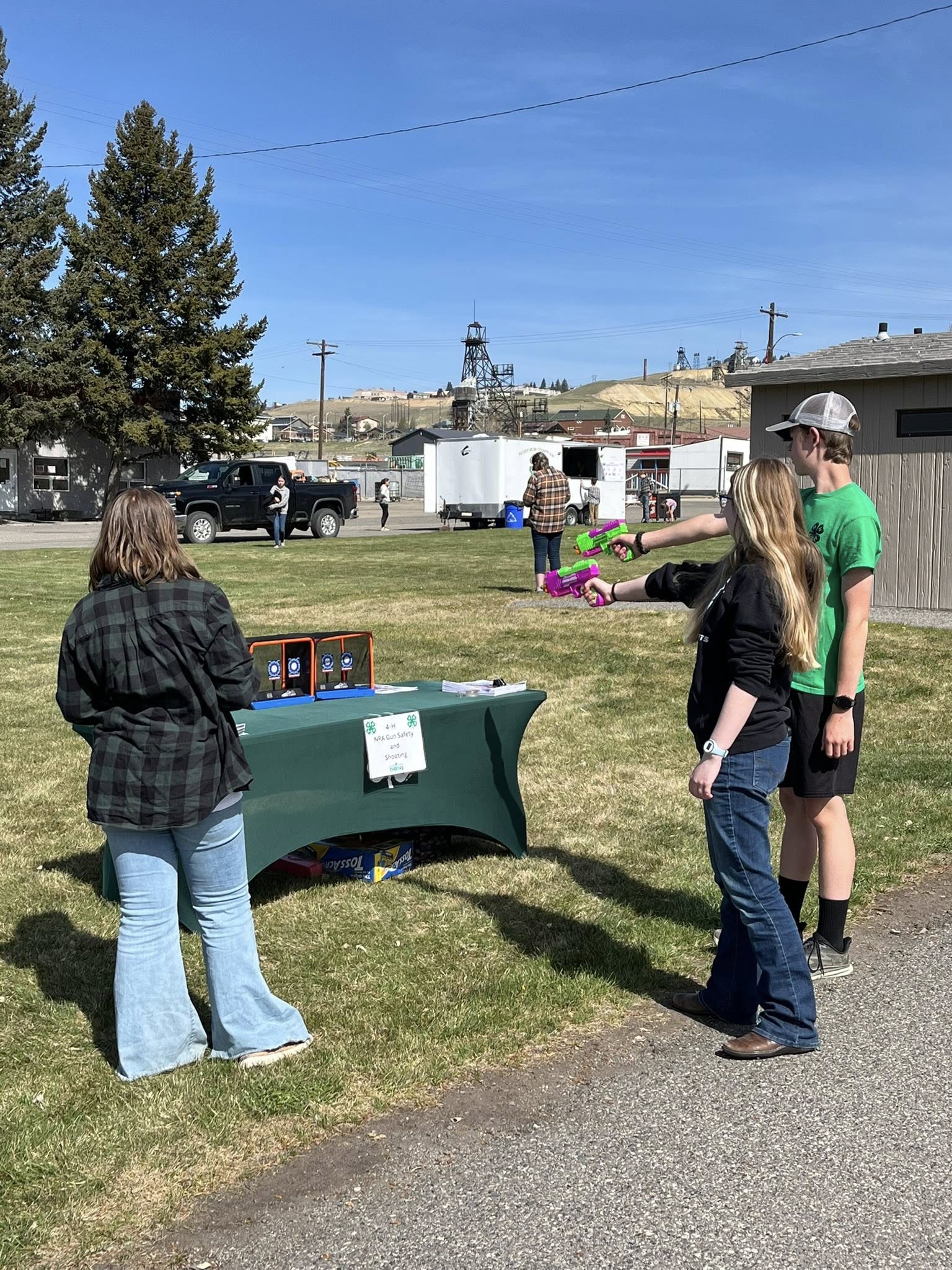 4-H member, Abi Shope, leading a shooting safety station at Youth Outdoor Day.