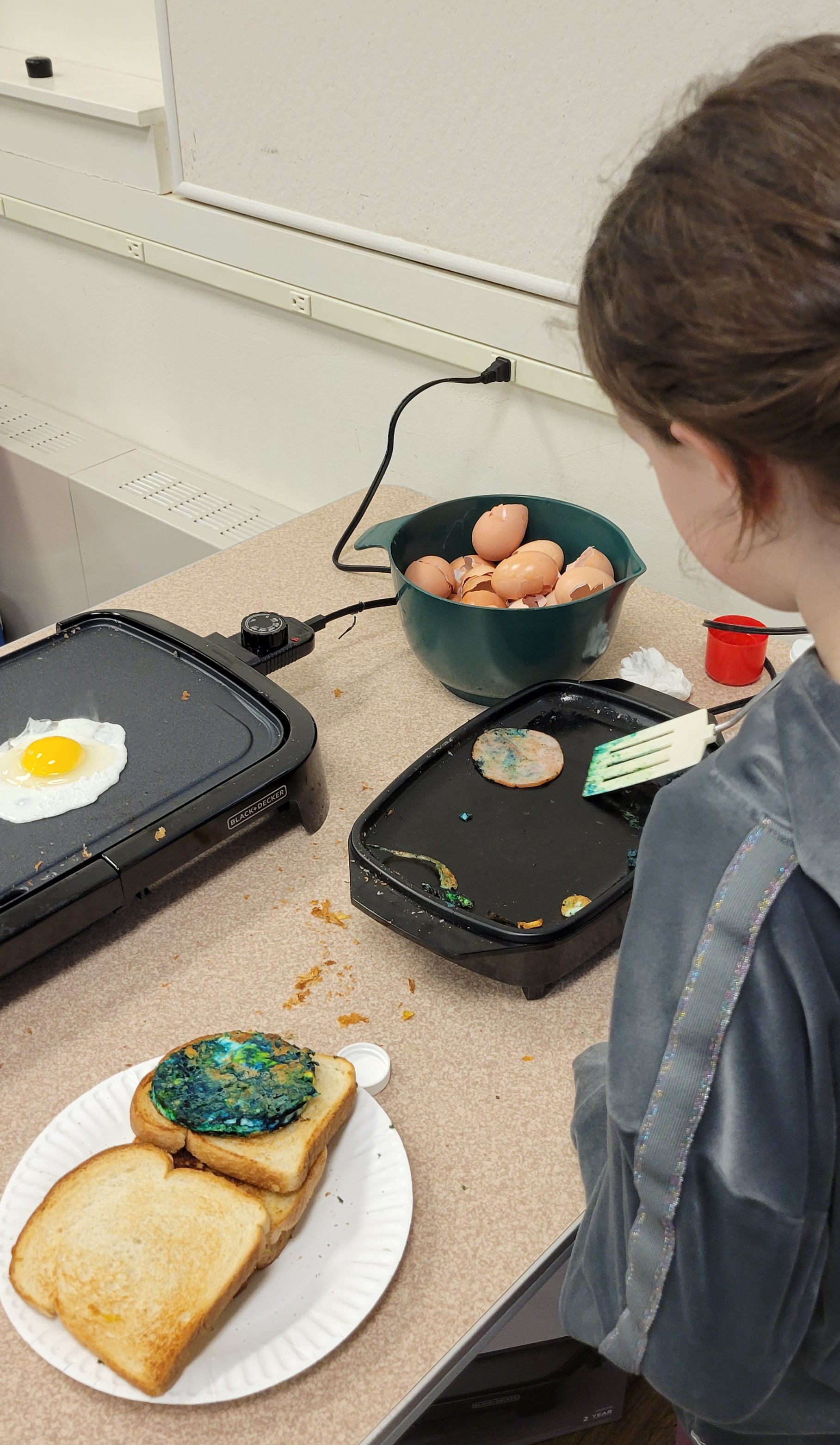 Cooking With Kids participant making green egg and ham sandwich