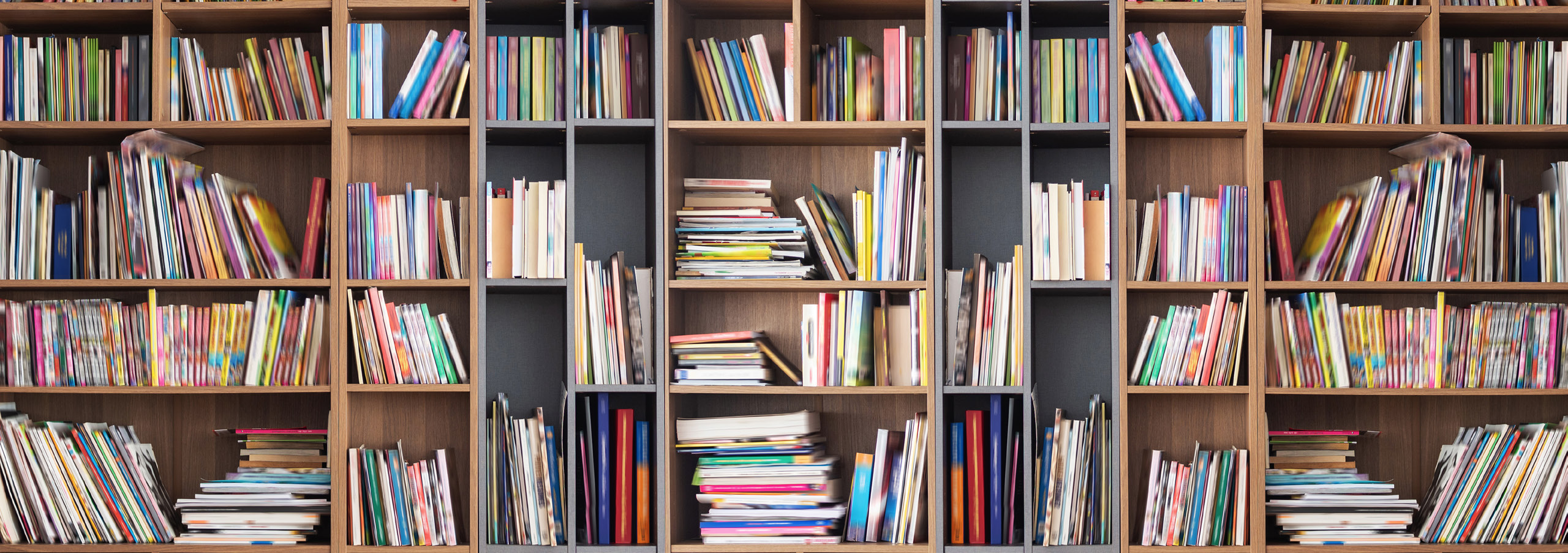 book shelf filled with colorful books.