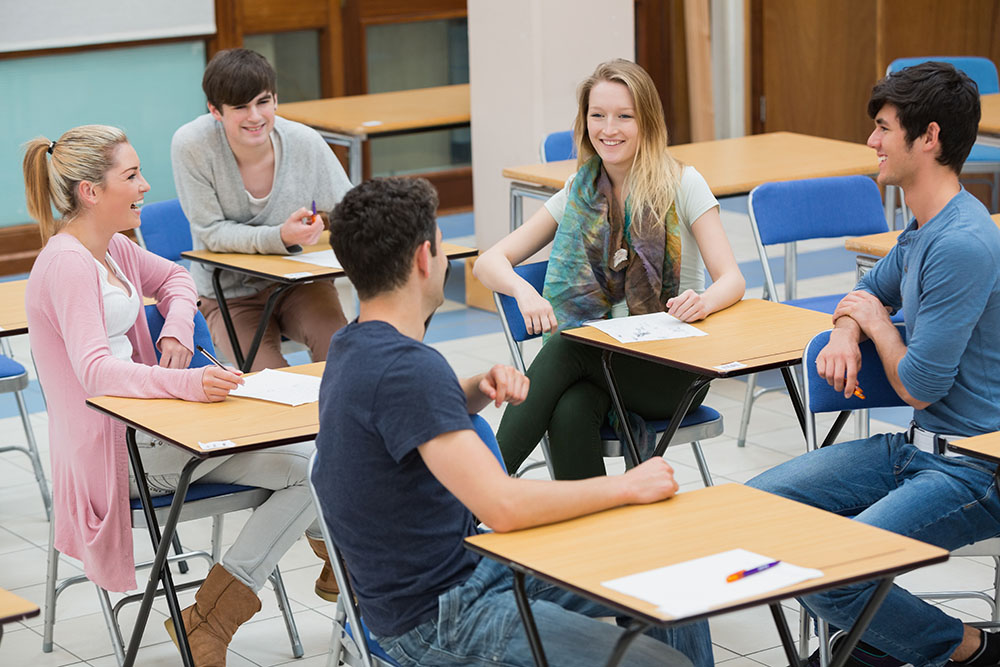 Students talking in a classroom.