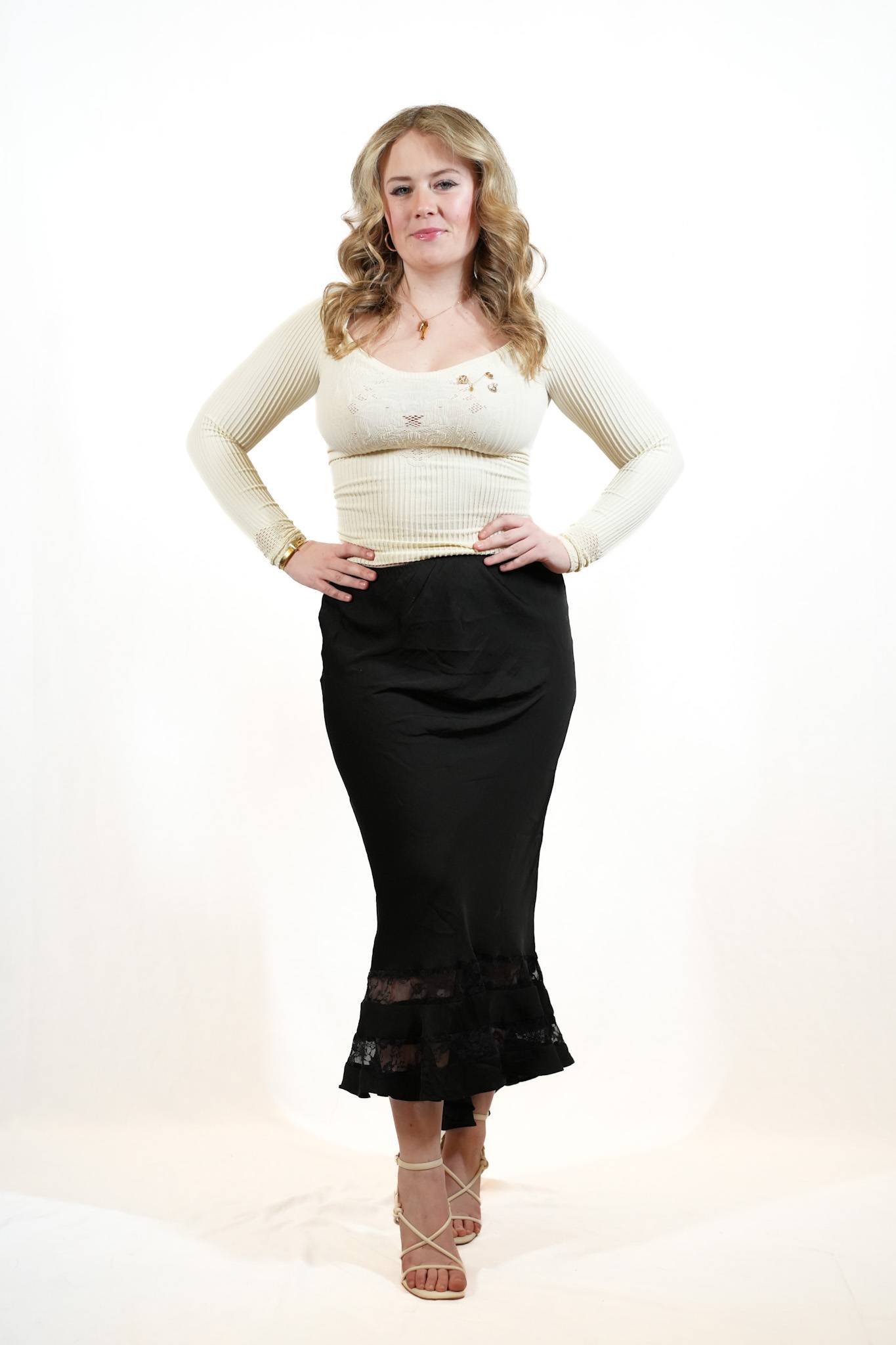 Female student wearing cream blouse and black skirt