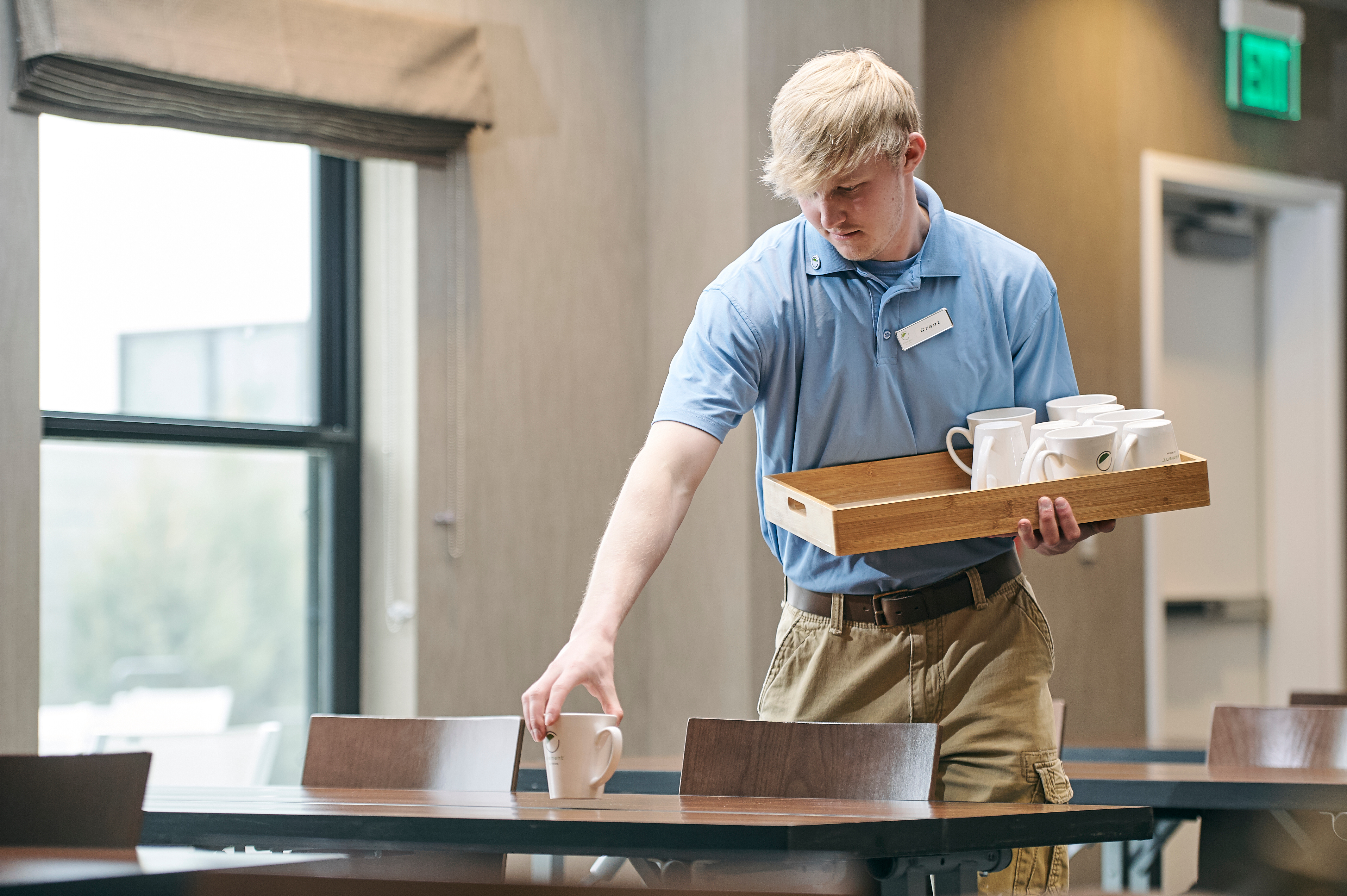 MSU student sets a hotel dining table