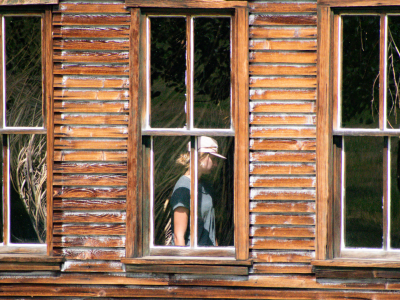 Honors College student walking through a replica school house.