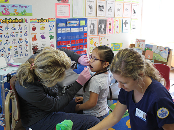 2 nurses with child