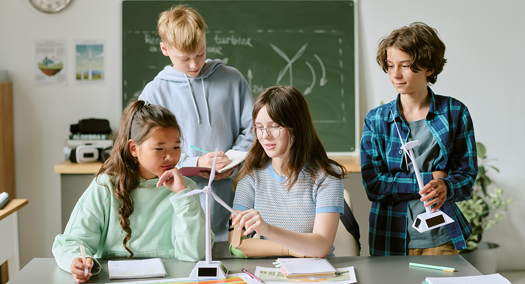 students working with wind turbine models in a classroom