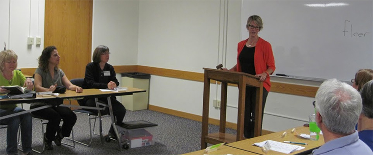 members of Toastmasters listen to a speaker